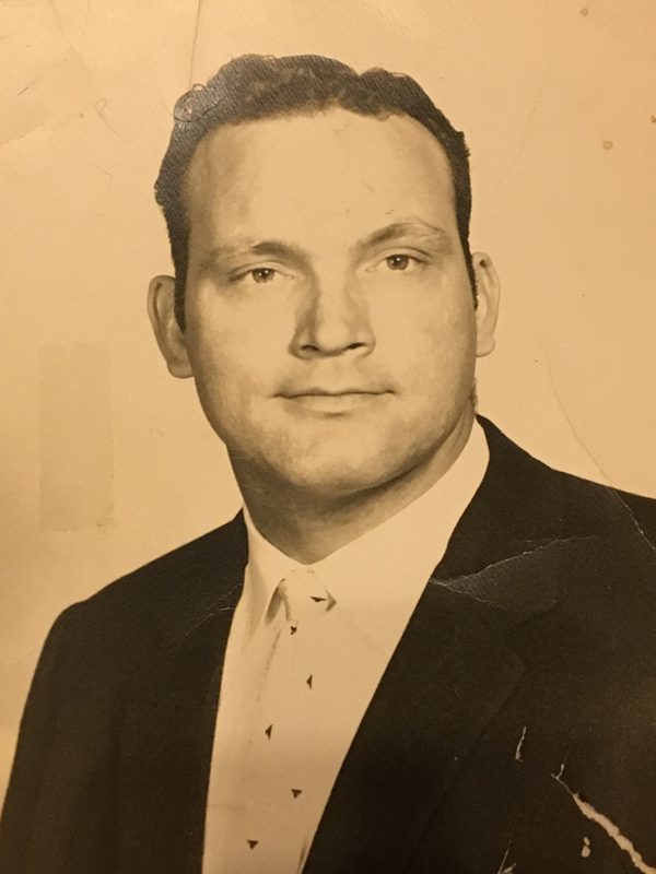 Portrait of a young Herb Adams in a suit and tie